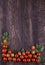 Border made from freshness sliced tomatoes on wood background. D