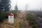 Borderline Bollard Along Footpath in Foggy Forest