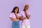 Bored African American couple with dull facial expressions on color background