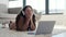 Bored Caucasian Woman Yawning While Lying on the Floor with Laptop