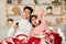 Bored Chinese Couple Watching TV Yawning Celebrating Christmas At Home