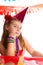 Bored gesture blond kid girl in party birthday hat