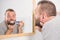 Bored guy brushing his teeth in bathroom