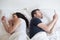 Bored lovers couple in bed and using mobile phones