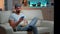 Bored man sitting on couch holding popcorn bowl