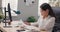 Bored pretty office secretary employee in a white shirt sits in front of the computer monitor, she is tired, wants to