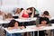 Bored student with classmates sleeping at desk