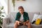 Bored teen boy holding joystick, sitting on couch