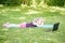 Bored tired girl child doing sport workout outdoor online. Video yoga class on Internet. Funny sleepy kid training at home