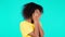 Bored upset african woman sighs on teal background. Pretty girl in displeasure, she is tired of situation. Unhappy lady
