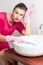 Bored woman cleaning washbasin