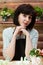 Bored woman flower shop clerk stands behind counter