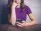 Bored woman using smartphone at table