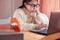 Bored woman working on laptop in workplace at home. Businesswoman in glasses using laptop sitting in office and doing research