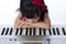 Boring Asian Chinese little girl playing electric piano keyboard