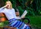 Boring literature. Woman yawning blonde take break relaxing in garden reading book. Girl sit bench relaxing with book