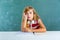 Boring sad expression student schoolgirl on desk