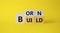 Born and Build symbol. Turned wooden cubes with words Build to Born. Beautiful yellow background. Business and Born and Build