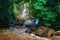 Borneo rain forest waterfall, idyllic stream flowing in the lush green jungle of Kubah National Park, Sarawak, Malaysia. Blurred e