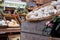 Borough Market, market in Southwark, London UK, with wide range of food stalls. Wooden crate and basket of garlic in foreground.