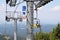 Borovets Resort, Bulgaria - July 31, 2016: Mountain biker with his bike on a chairlift heading to Rila mountain hills