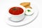 Borsch with croutons in a white plate on a white background