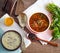 Borsch and mushroom soup served on table