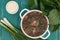 Borsch from a nettle on wooden table. Top view