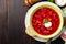 Borsch - traditional Ukrainian and Russian beetroot soup on dark wooden background