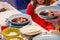Borscht, borsch with ravioli, red beet soup, traditional Polish Christmas meal, dish served on the family table, detail, closeup.