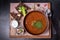 Borscht in a brown porcelain dish with bread