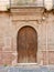 Bosa, Sicilia, Italy - April 1, 2023: vintage old door made in Italian tradition with columns and coat of arms