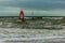 Boscombe, Dorset / United Kingdom - January 26, 2019:  Windsurfer in a rough water and dark sky