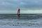 Boscombe, Dorset / United Kingdom - January 26, 2019:  Windsurfer in a rough water and dark sky