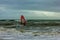 Boscombe, Dorset / United Kingdom - January 26, 2019:  Windsurfer in a rough water and dark sky