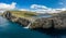 Bosdalafossur waterfall on Vagar island coastline aerial view