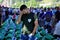 A Bosnian Muslim man sits and cries near the coffin of his relative at a memorial centre in Potocari