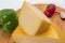 Bosnian traditional cheese served on a wooden container with peppers, parade and onions isolated on a white background