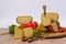 Bosnian traditional cheese served on a wooden container with peppers, parade and onions isolated on a white background