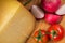 Bosnian traditional cheese served on a wooden container with peppers, parade and onions isolated on a white background