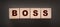 The boss sign on a wooden cubes on black. Business owner concept