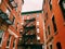 Boston brick red apartments buildings exterior with fire escape ladder
