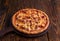 Boston Delight pizza isolated on cutting board top view on dark background italian fast food