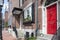 Boston, MA - April 8 2021: Front of brownstone apartment brick building with windows, shutters, stoops and planters in Boston