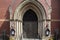 Boston, MA - April 8 2021: Victorian gothic building with red brick facade. Arched door into the Church of Advent in Boston