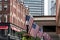 Boston, MA USA Shopping Mall Store front with american flags waving with skyscrapers in the background skyline