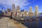 Boston skyline with skyscrapers reflections into the ocean and rusty chain on the foreground