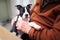 Boston Terrier puppy in the arms of a senior man. The puppy has her paw on his arm and she is holding her head up alert. They are