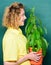 Botanical expert. Botany education. Botany is about plants flowers and herbs. Woman chalkboard background carry plant in