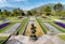 Botanical Gardens of Villa Taranto with bronze statue The Fisher in front, Pallanza, Italy.